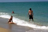 Siblings bonding with strange man's head in the background